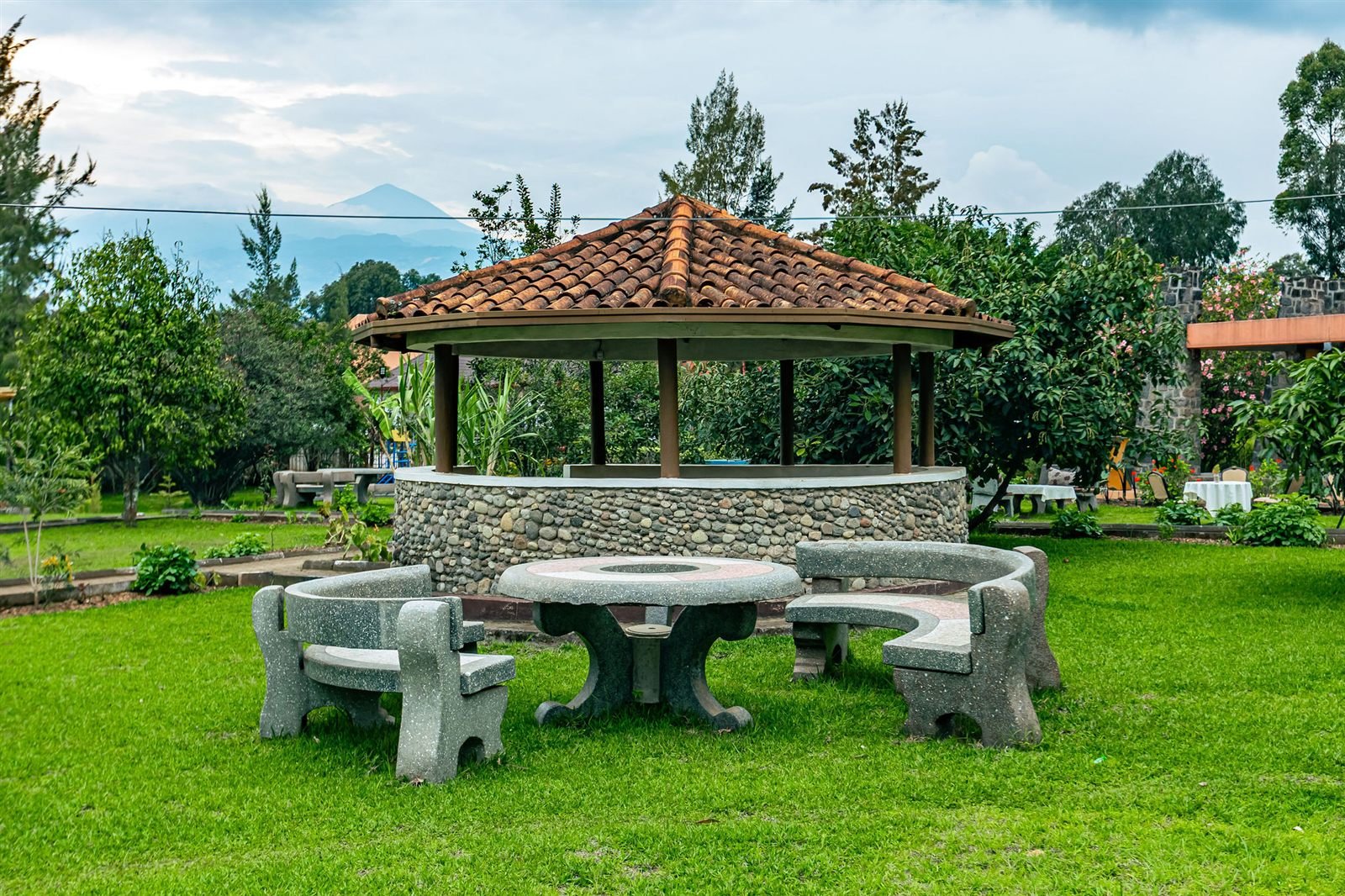 Stone gazebo with a table in the resort gardens