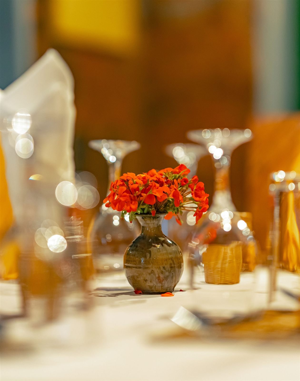Glassware and a small flower arrangement on a table