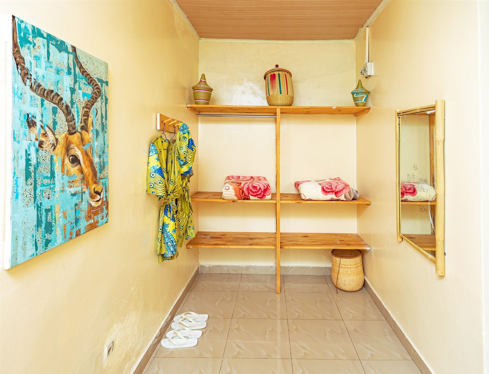 African-style room with painted wall art, woven shelves and a bamboo mirror
