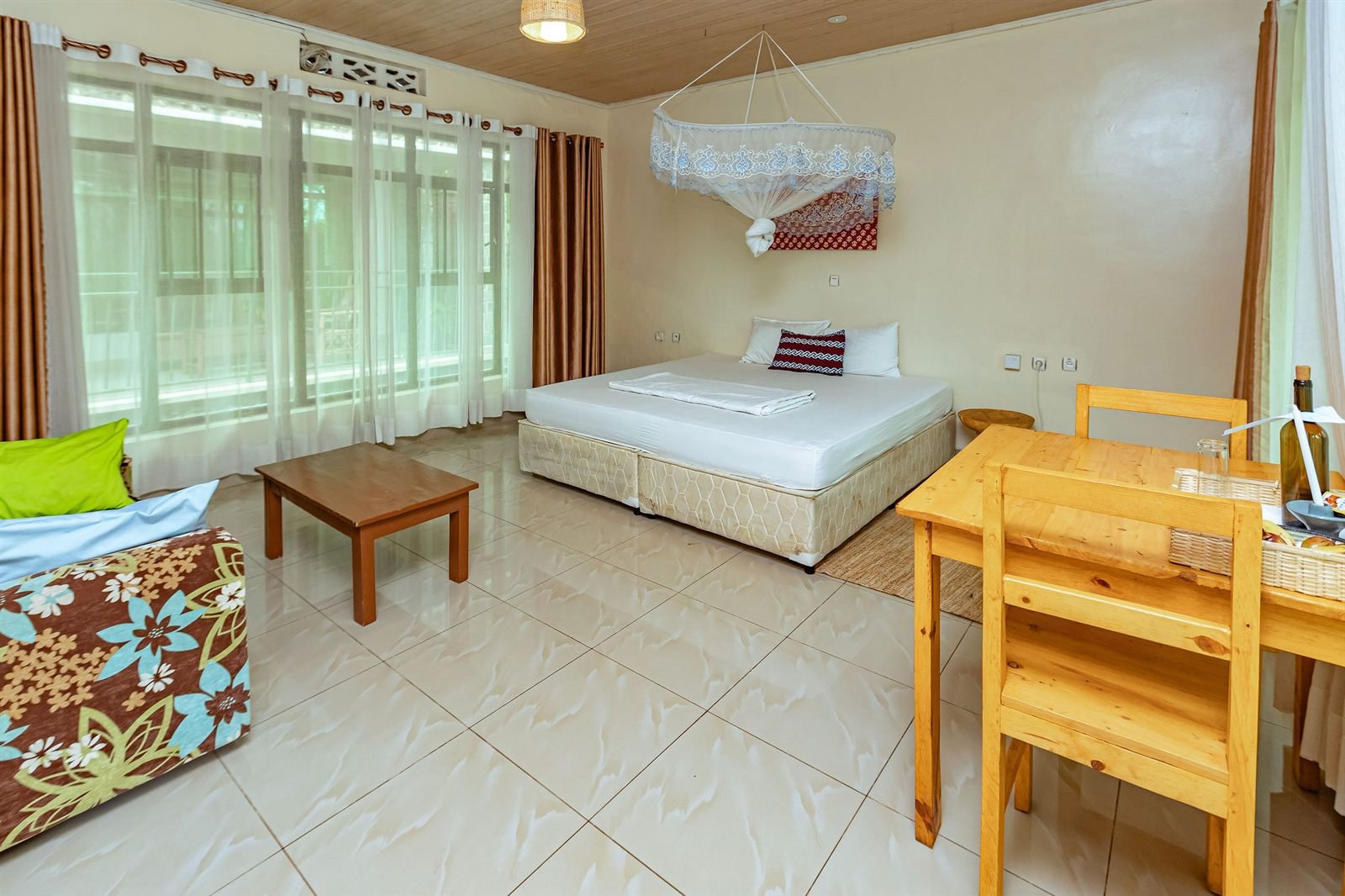 Single room with a white bed and a wooden writing table