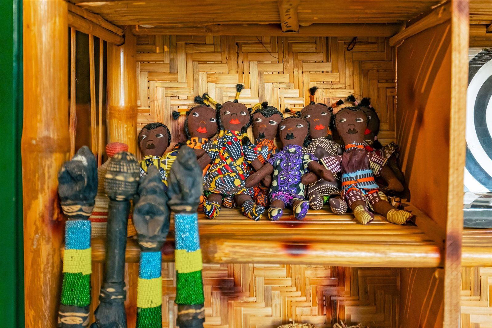 Hand-carved figures on a wooden shelf